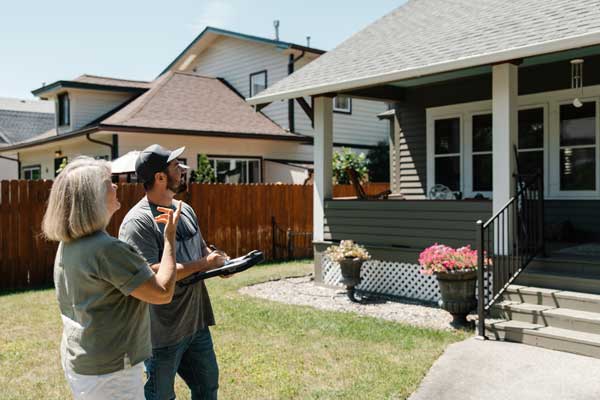 Nathan and client evaluating roof.