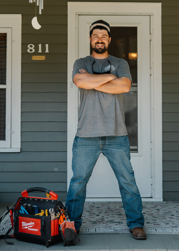 Nathan standing on porch. 